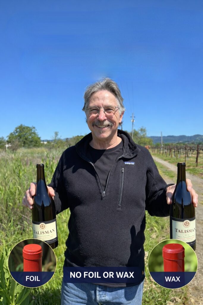 Talisman winemaker Scott Rich holding two bottles of Pinot Noir in the vineyard, representing sustainable winemaking and thoughtful vineyard practices in Sonoma County.